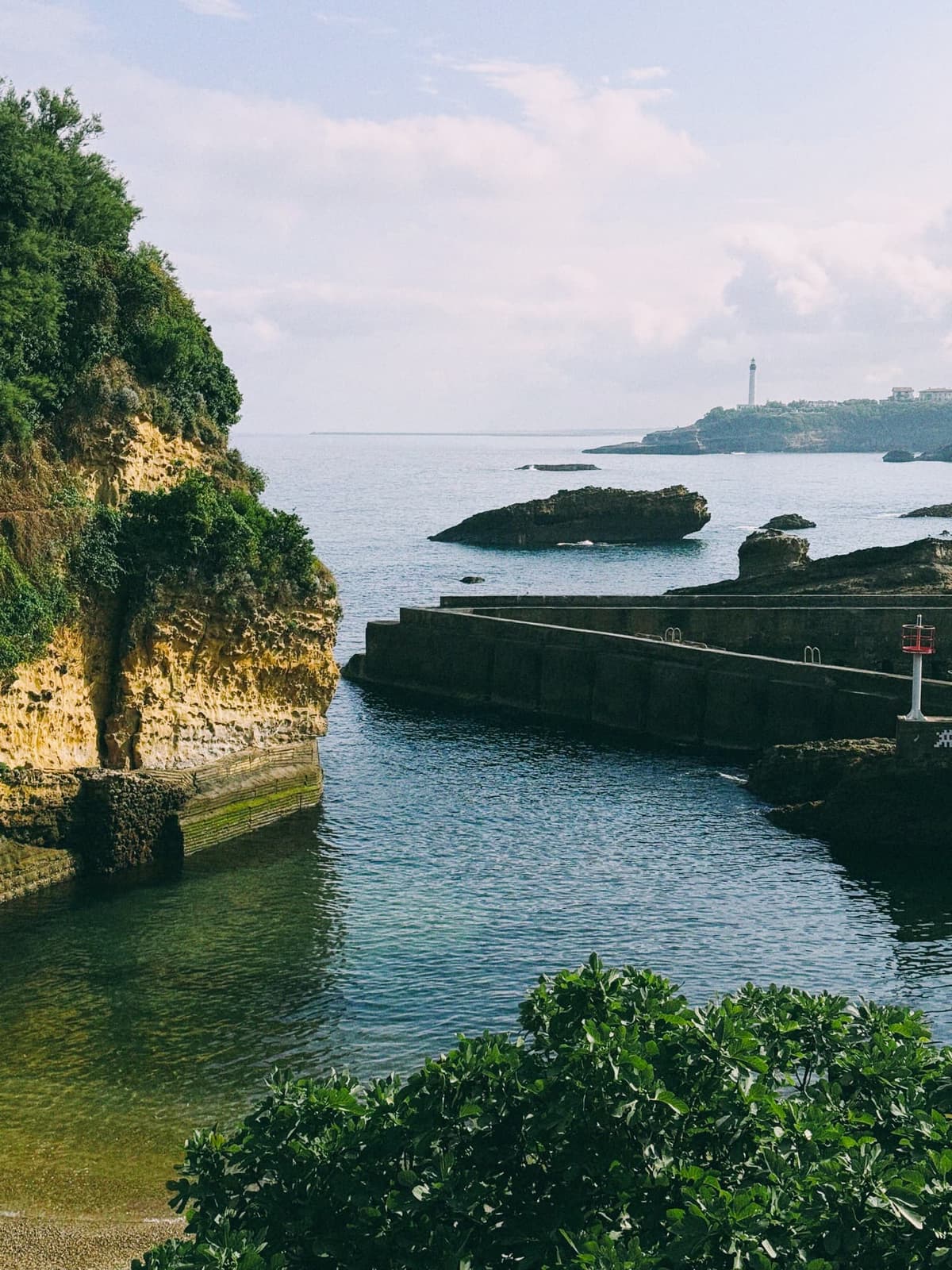 The old fishing port — breakwaters holding a pocket of green-glass water