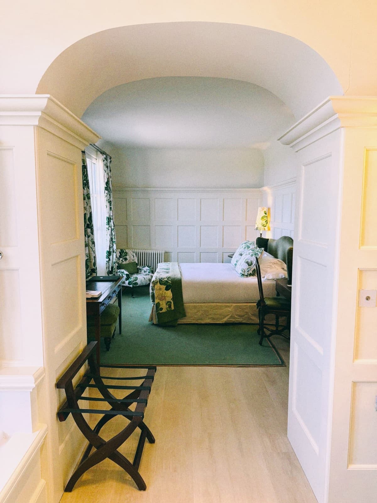 Through the doorway — green carpet, panelled walls, a bed worth the drive