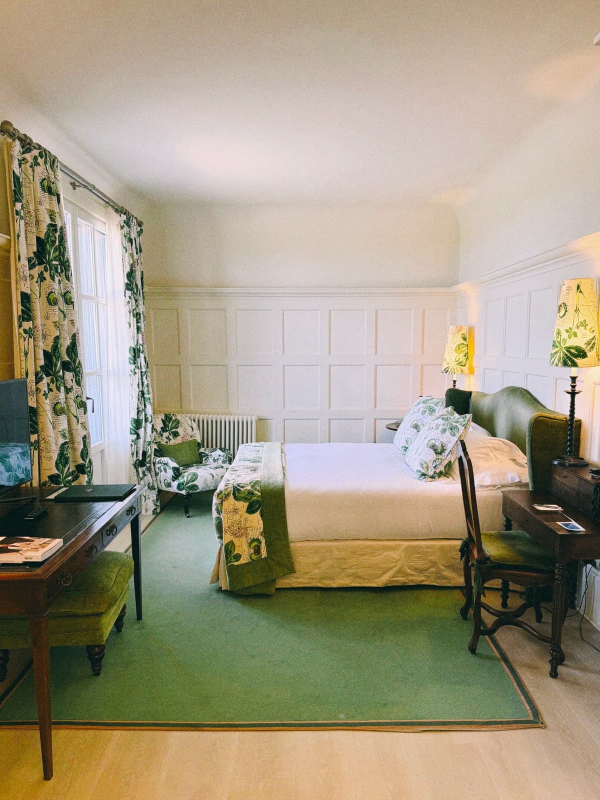 The green room, floral curtains, a desk nobody plans to use