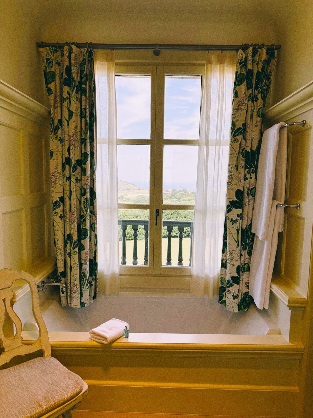 A window seat aimed at the countryside, towels warming in the sun