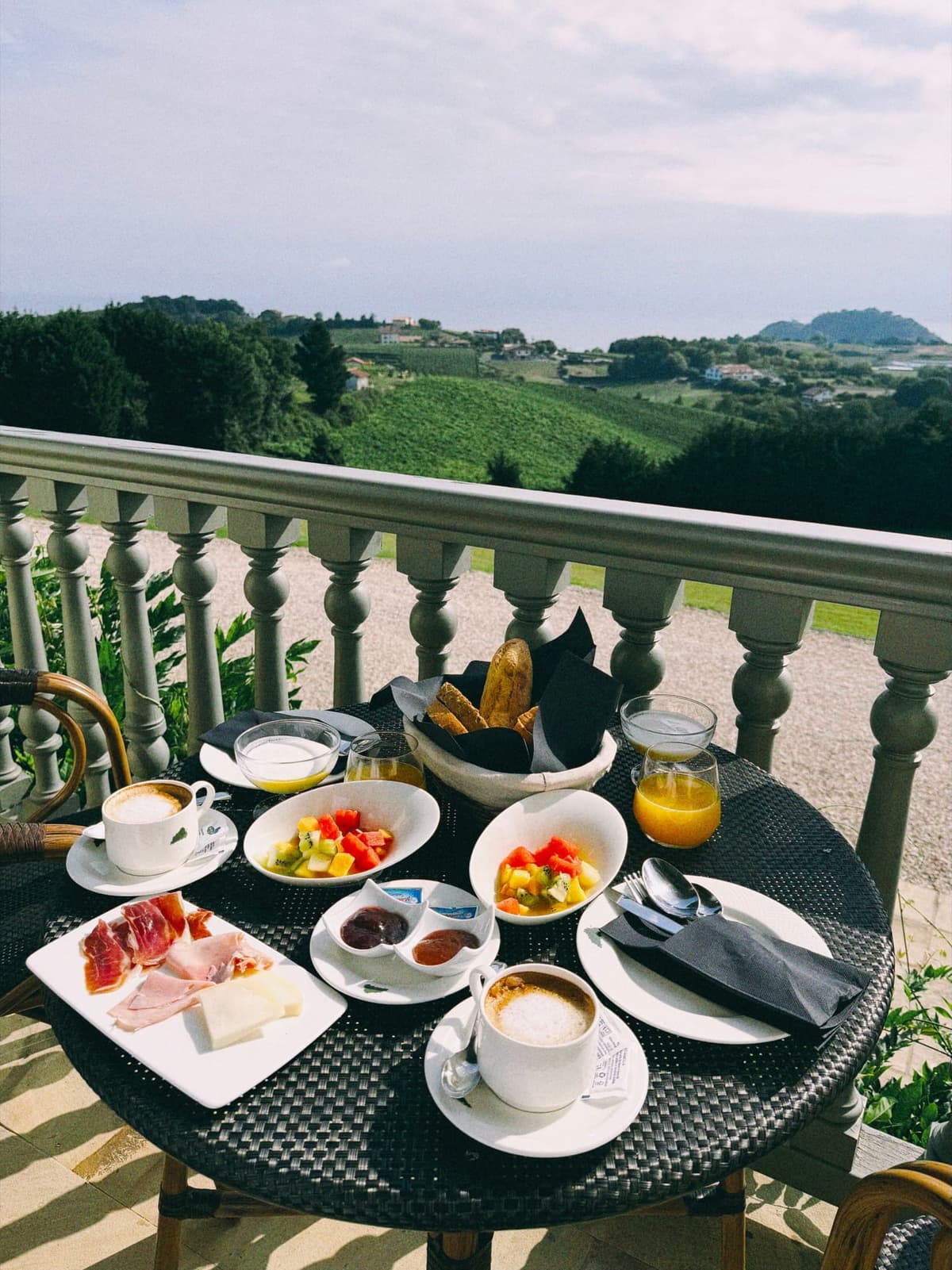 Breakfast on the balcony, txakoli vines running down to the sea