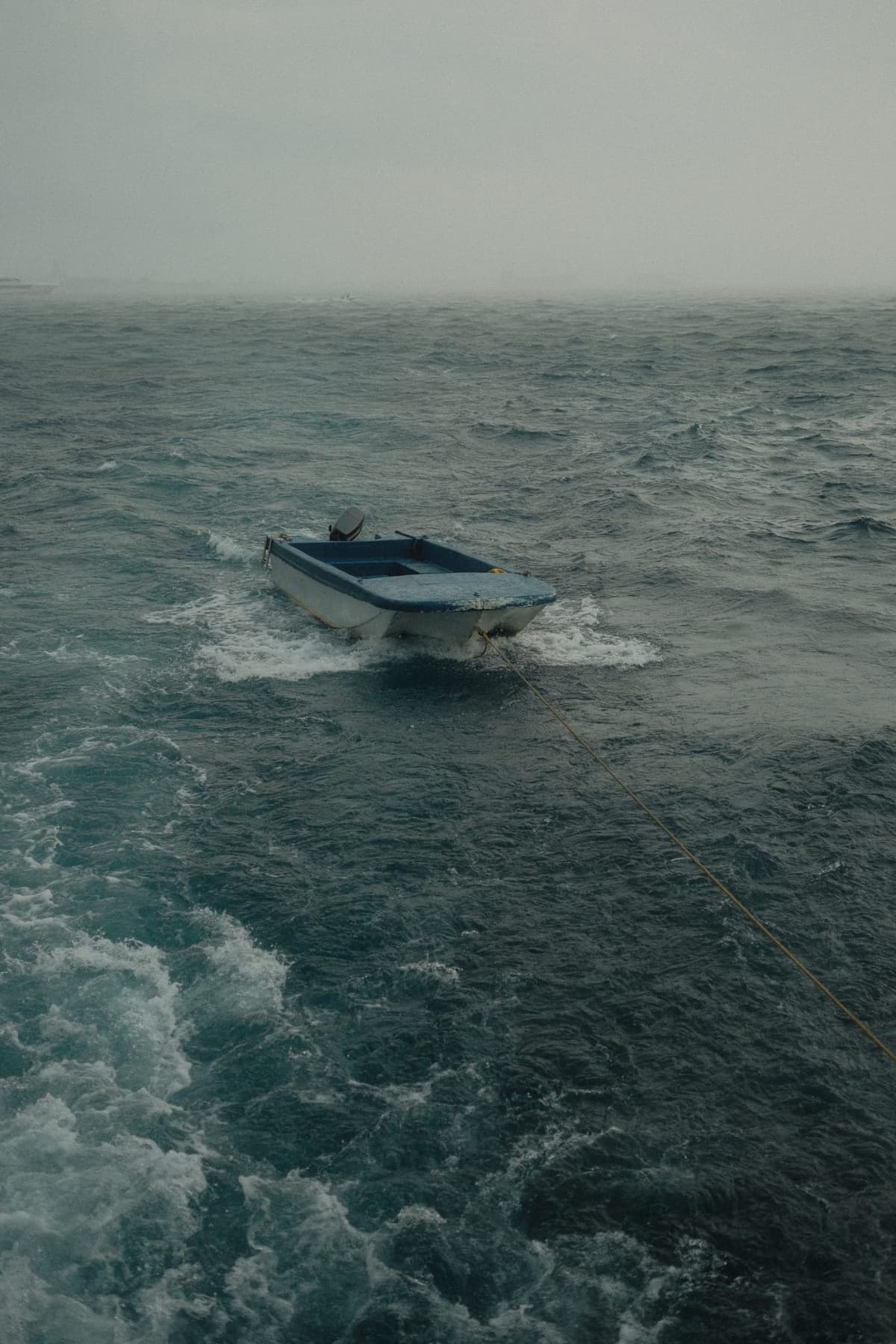 Small boat on a rope, thrashing through the squall