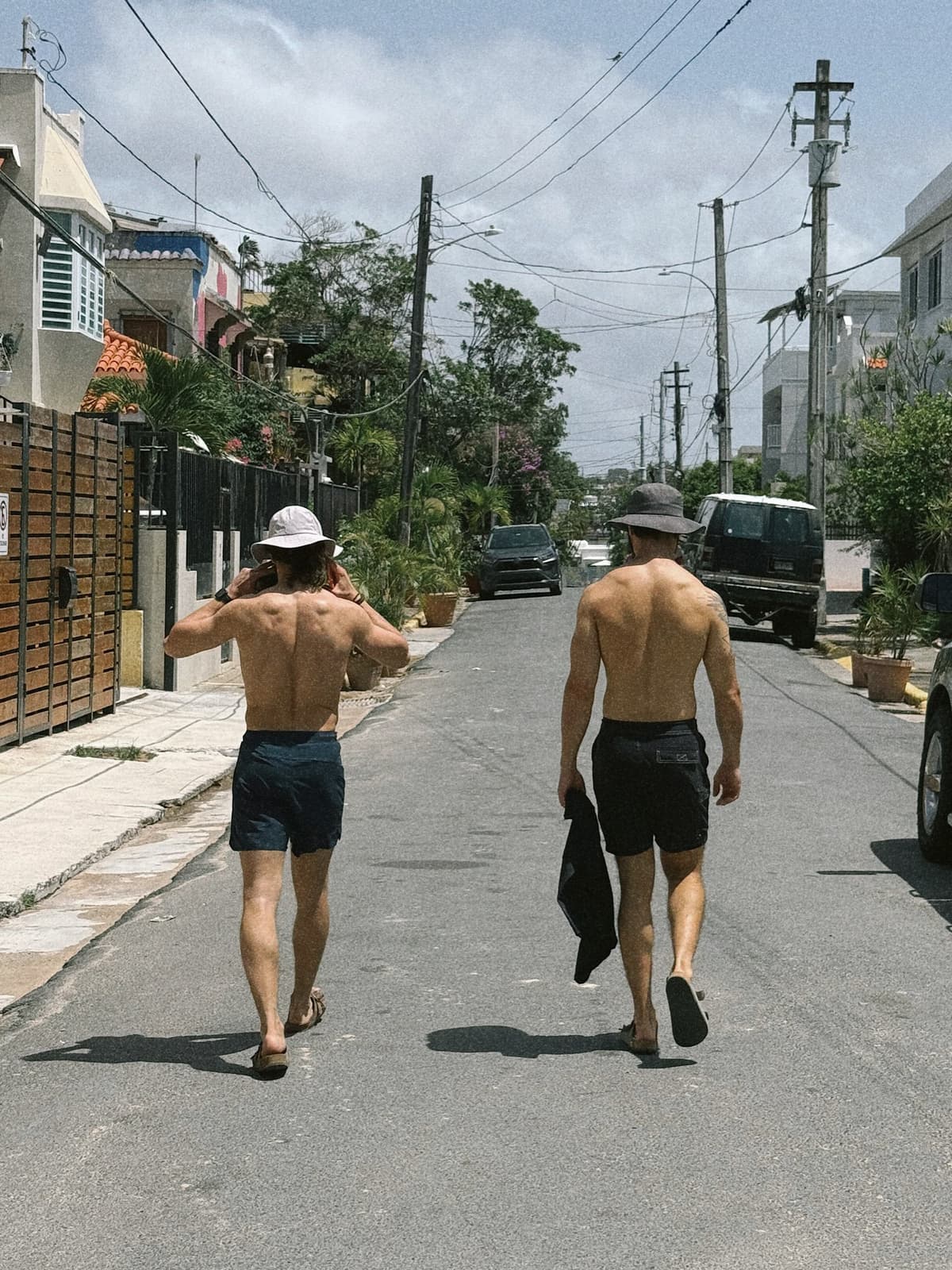 Two of us ambling down a sun-bleached street, back from the beach