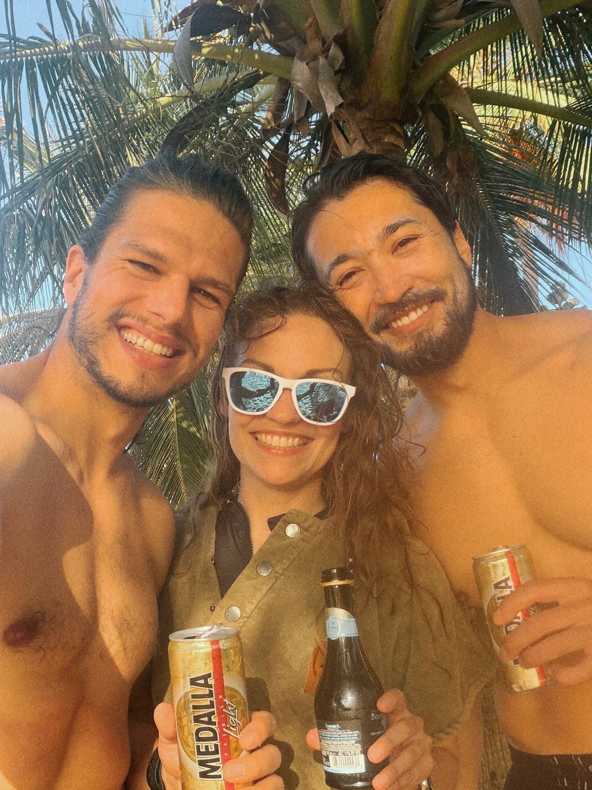 Sun-drunk selfie under a palm, Medallas in hand